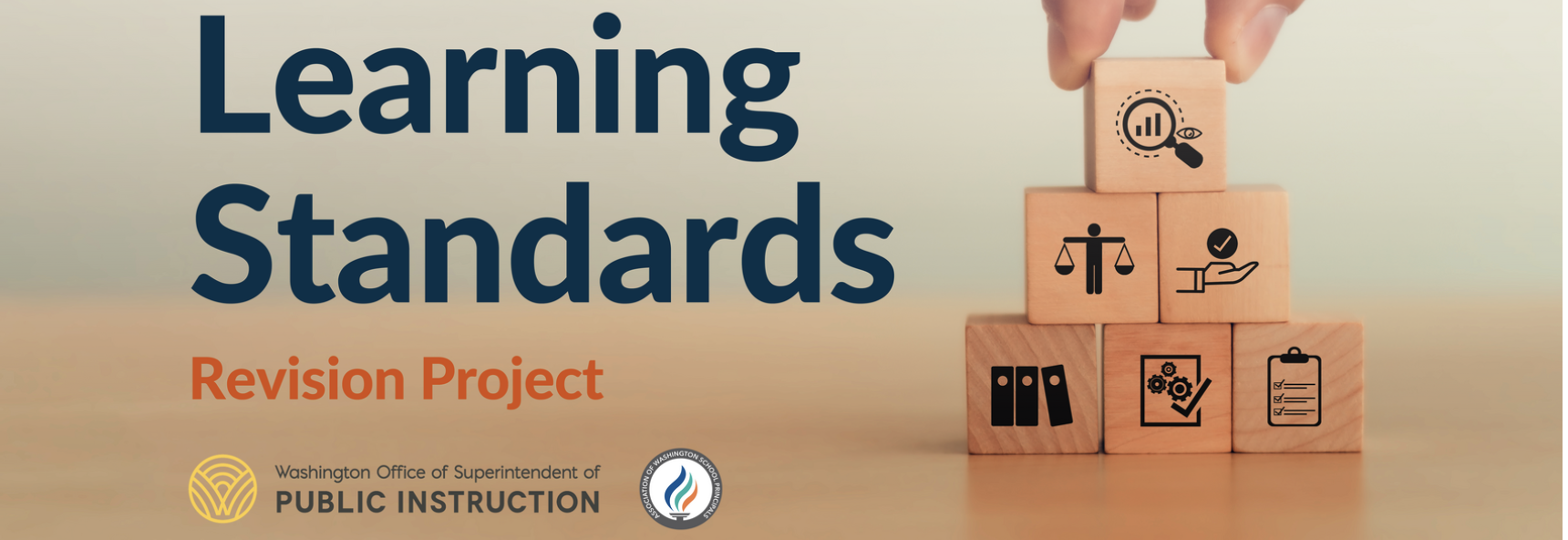 LSR Image with title 'Learning Standards Revision Project.' Wooden blocks stacked in a pyramid feature icons like a magnifying glass, scales of justice, a hand with a checkmark, folders, gears, and a checklist. Logos for OSPI and AWSP logos are at the bottom.