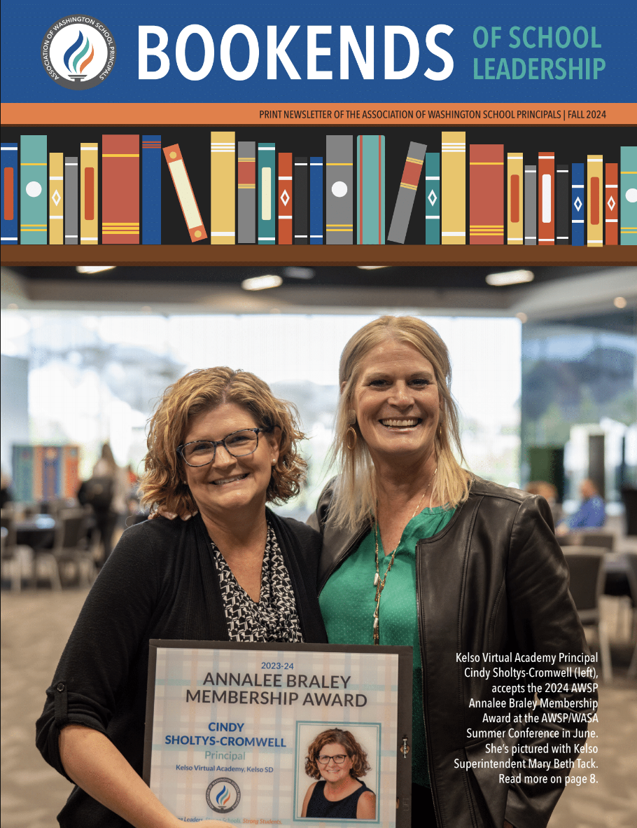 Two women smile, one holding an award plaque for the 2024 Annalee Braley Membership Award.