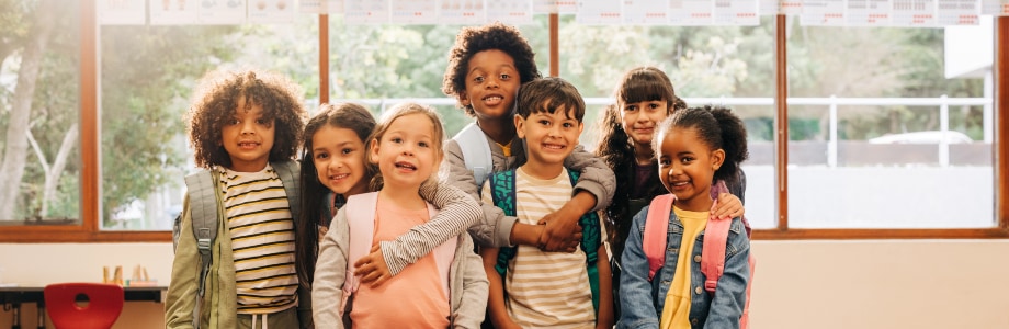 Group of elementary school students standing together in a classroom