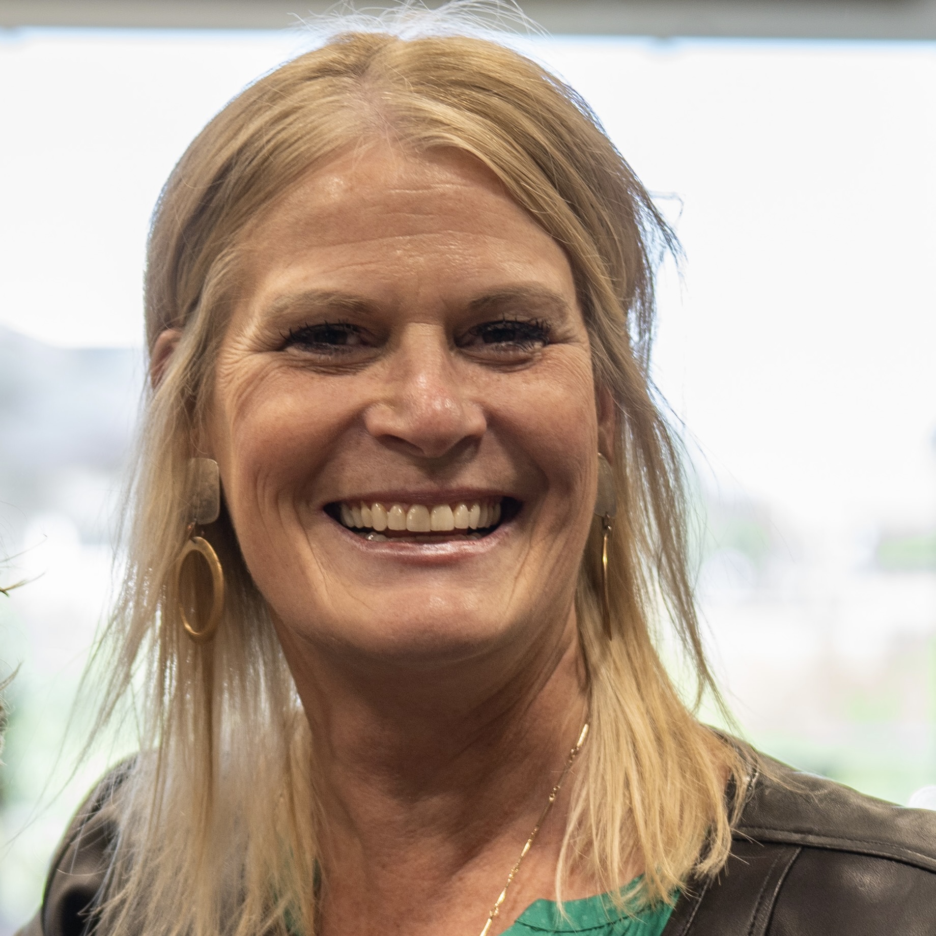 a photo of a blonde woman smiling, her name is Mary Beth Tack