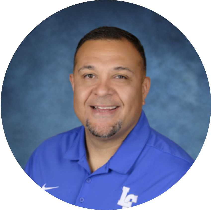 PODCAST | Manny Rangel on Relationships, Advocacy, and Belonging Headshot of Manny Rangel smiling in a blue polo shirt against a blue studio background.