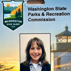 a woman smililng on a washington state parks id badge